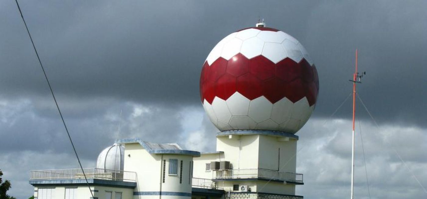Building with large red and white weather dome