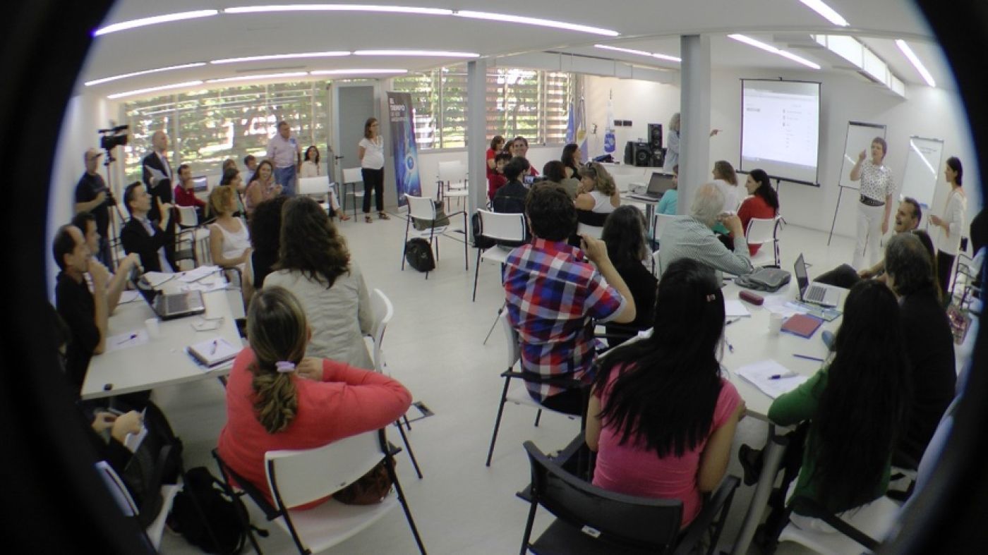 Fish-eye lens photo of people watching slide presentation in classroom